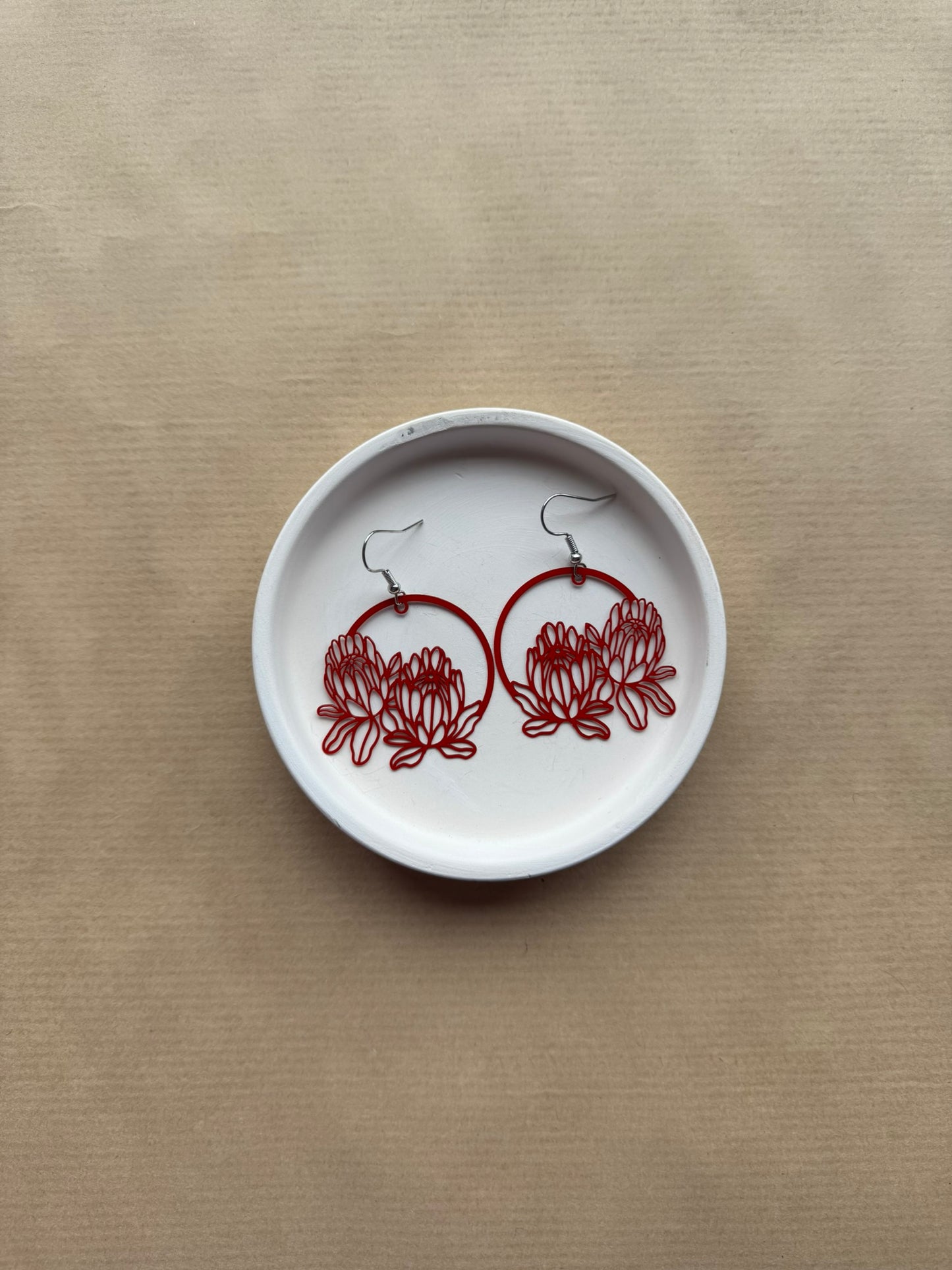 White dish with red floral designs on a beige background