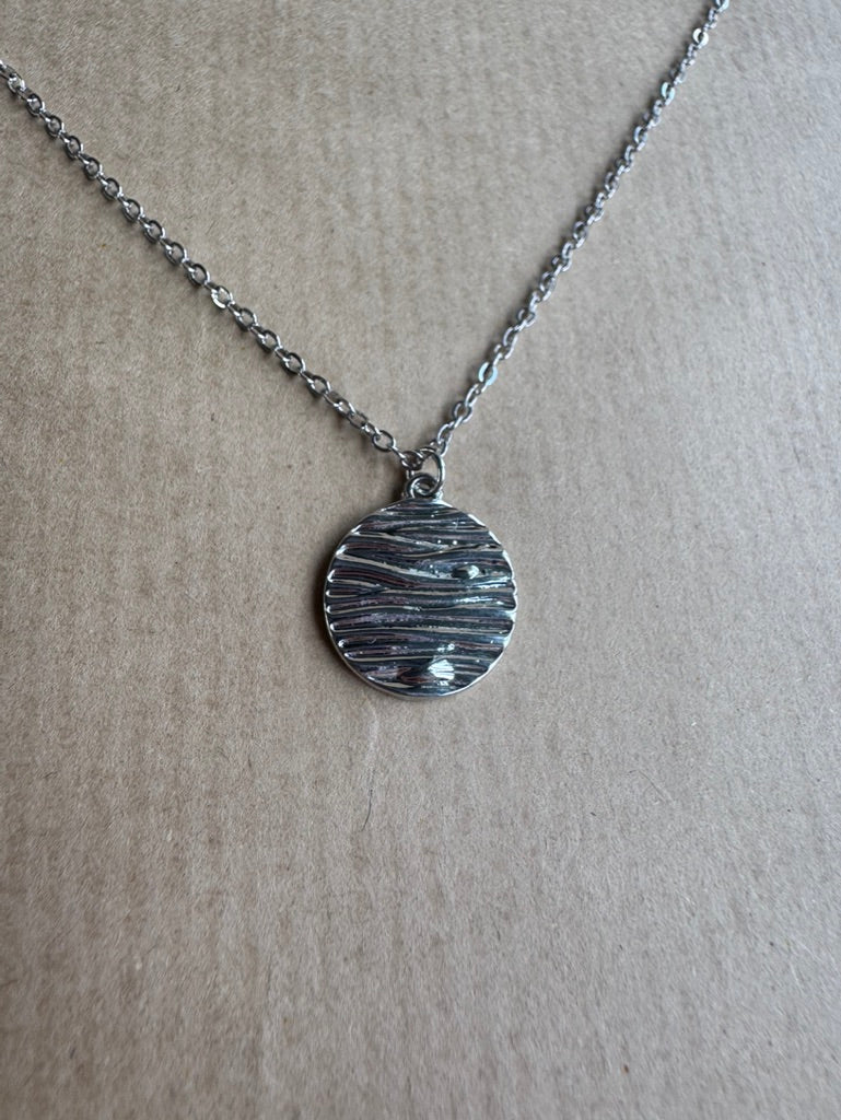 silver necklace charm up close 
