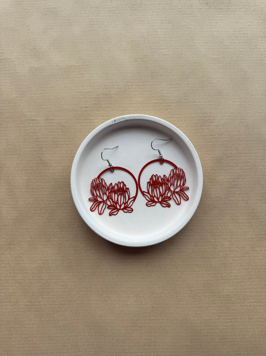 White dish with red floral designs on a beige background